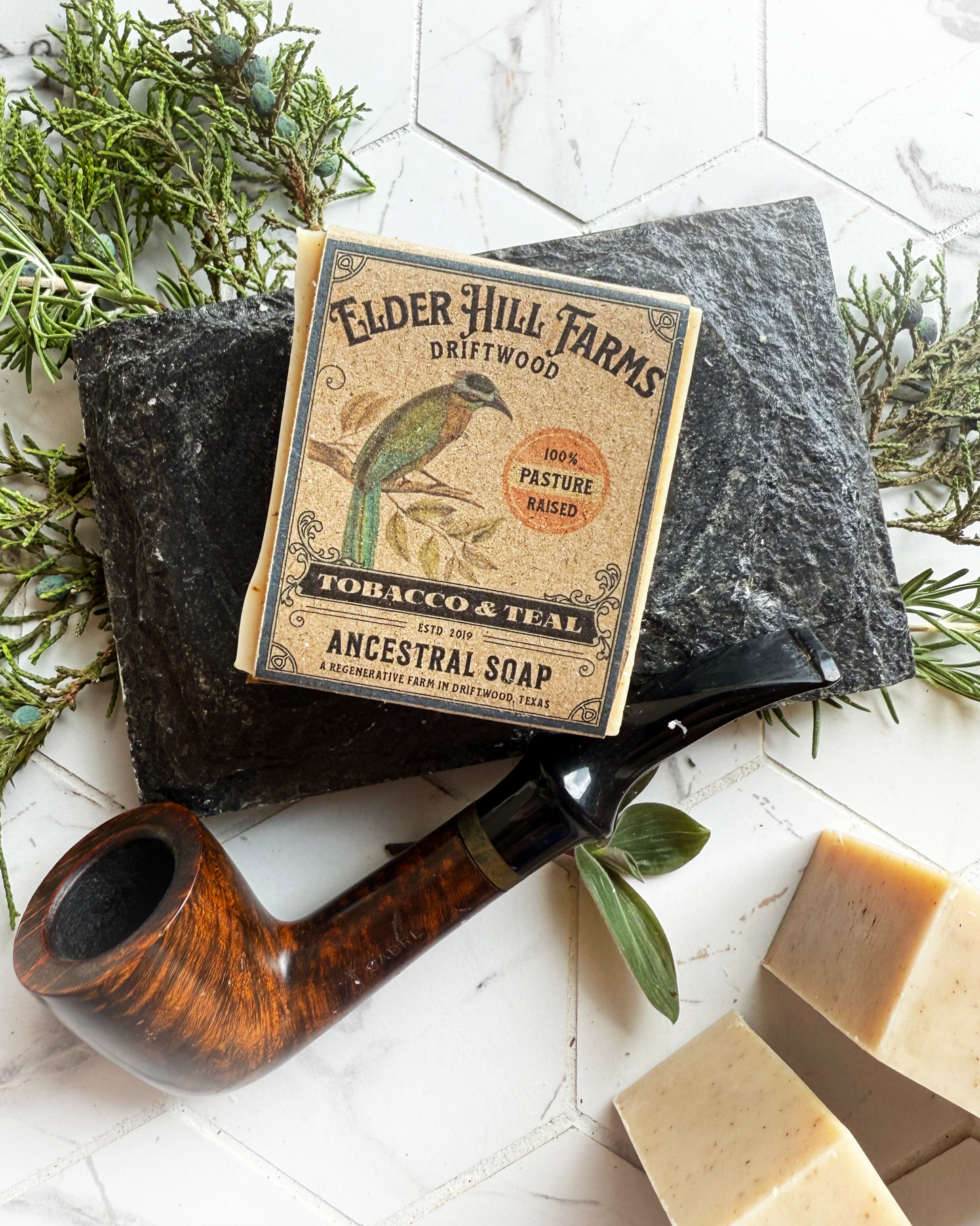Elder Hill Farms soap with a pipe and soap bars on a white background