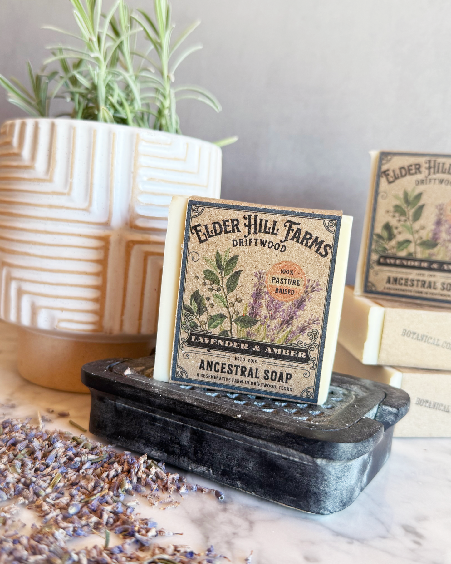 Elder Hill Farms soap packaging on a stand with lavender and amber theme