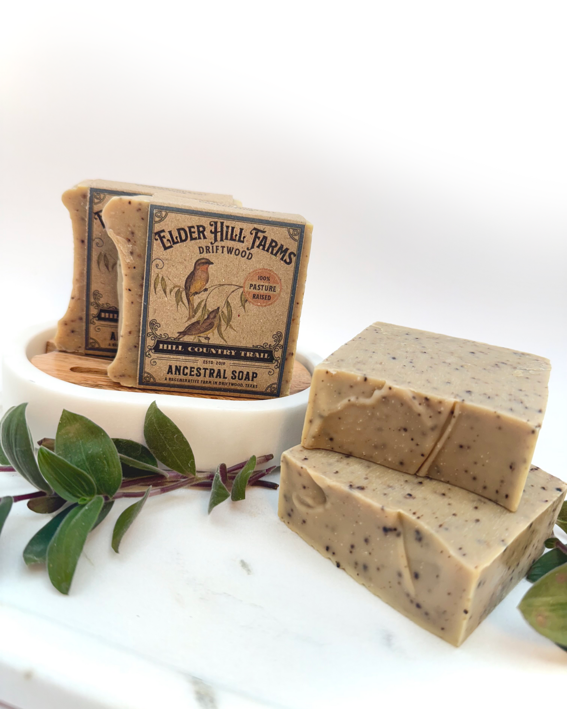 Two bars of soap with a box labeled 'Elder Hill Farms' on a white background